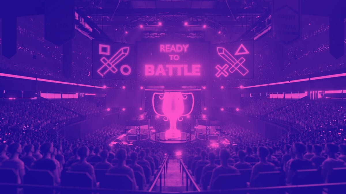 Packed esports arena with a giant Ready to Battle screen and a trophy on the stage