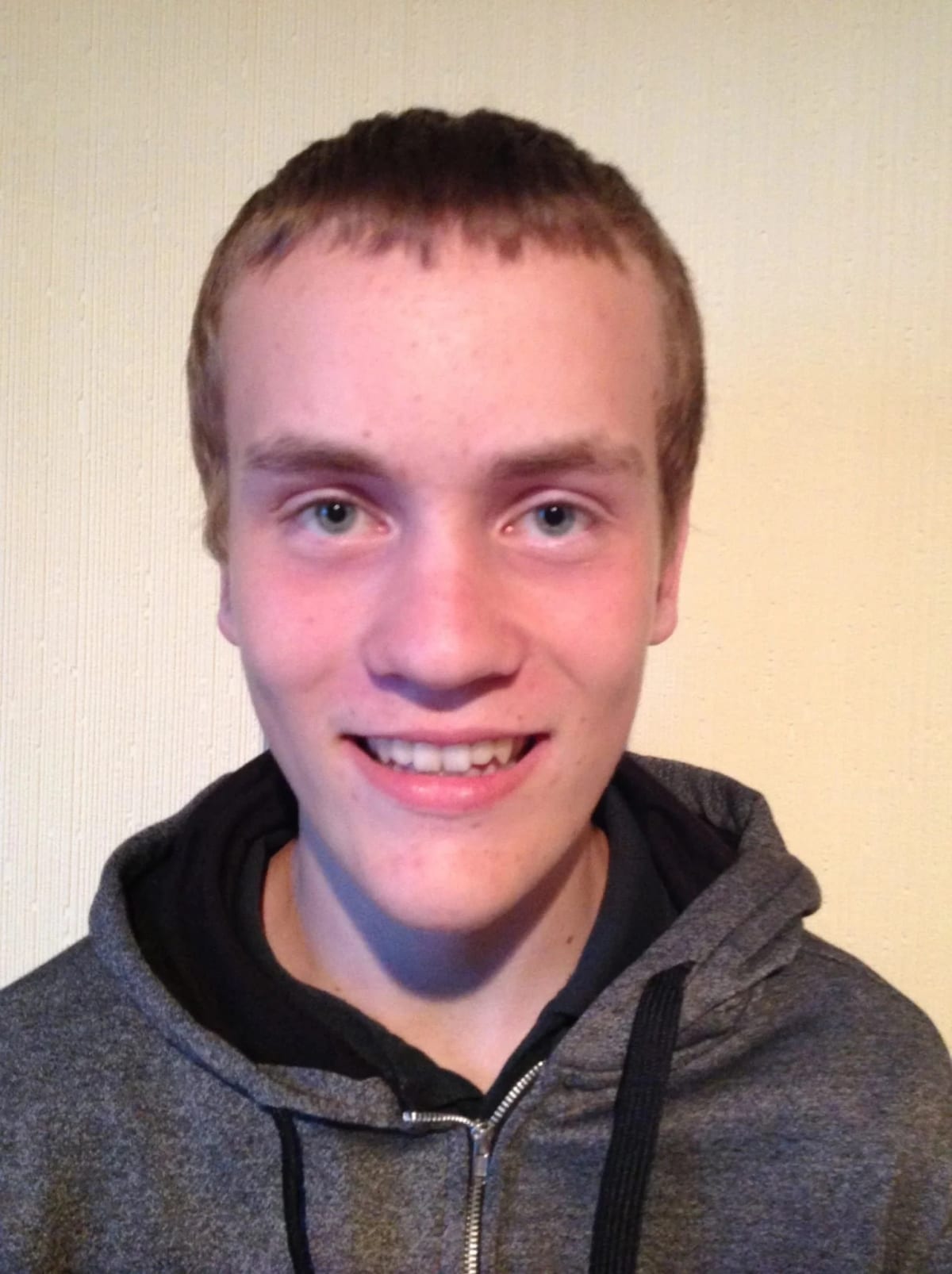 Portrait of BearHammer Games lead UI programmer Sandy Fisher in a grey hoodie